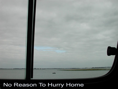 a far away boat with two men fishing on the oosterschelde_me driving in car over the philipsdam_title:no reason to hurry home